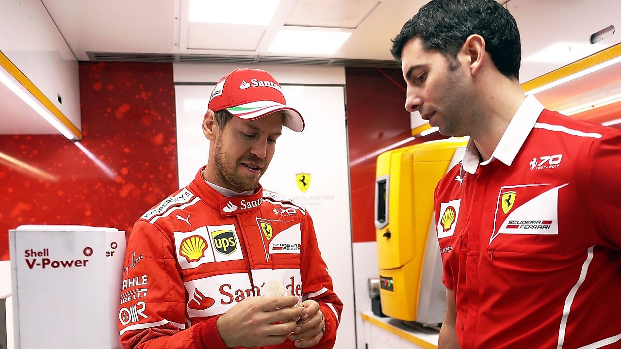 Sebastian Vettel and a Ferrari scientist inside a Shell lab